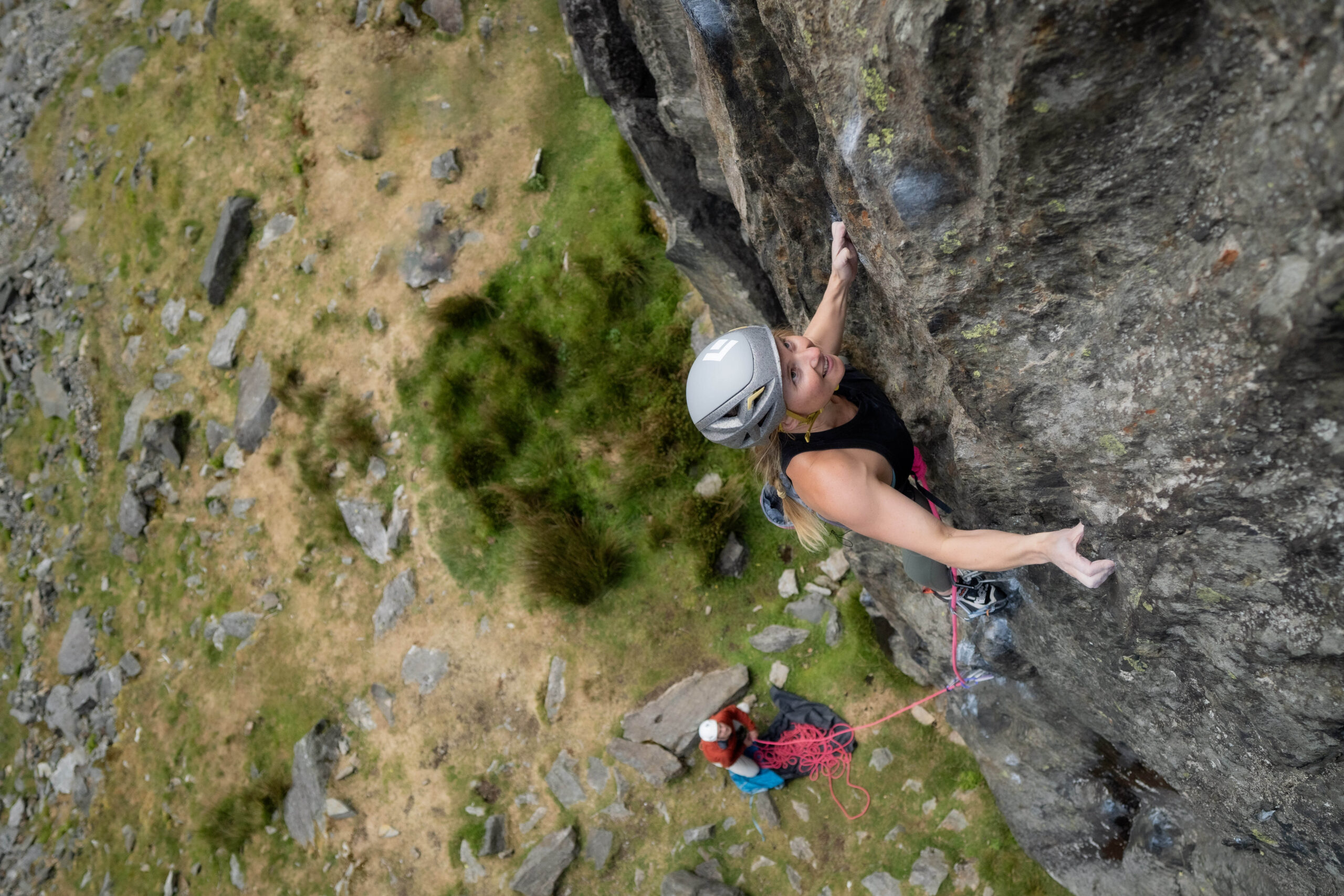 Climber moving up a steep rock wall