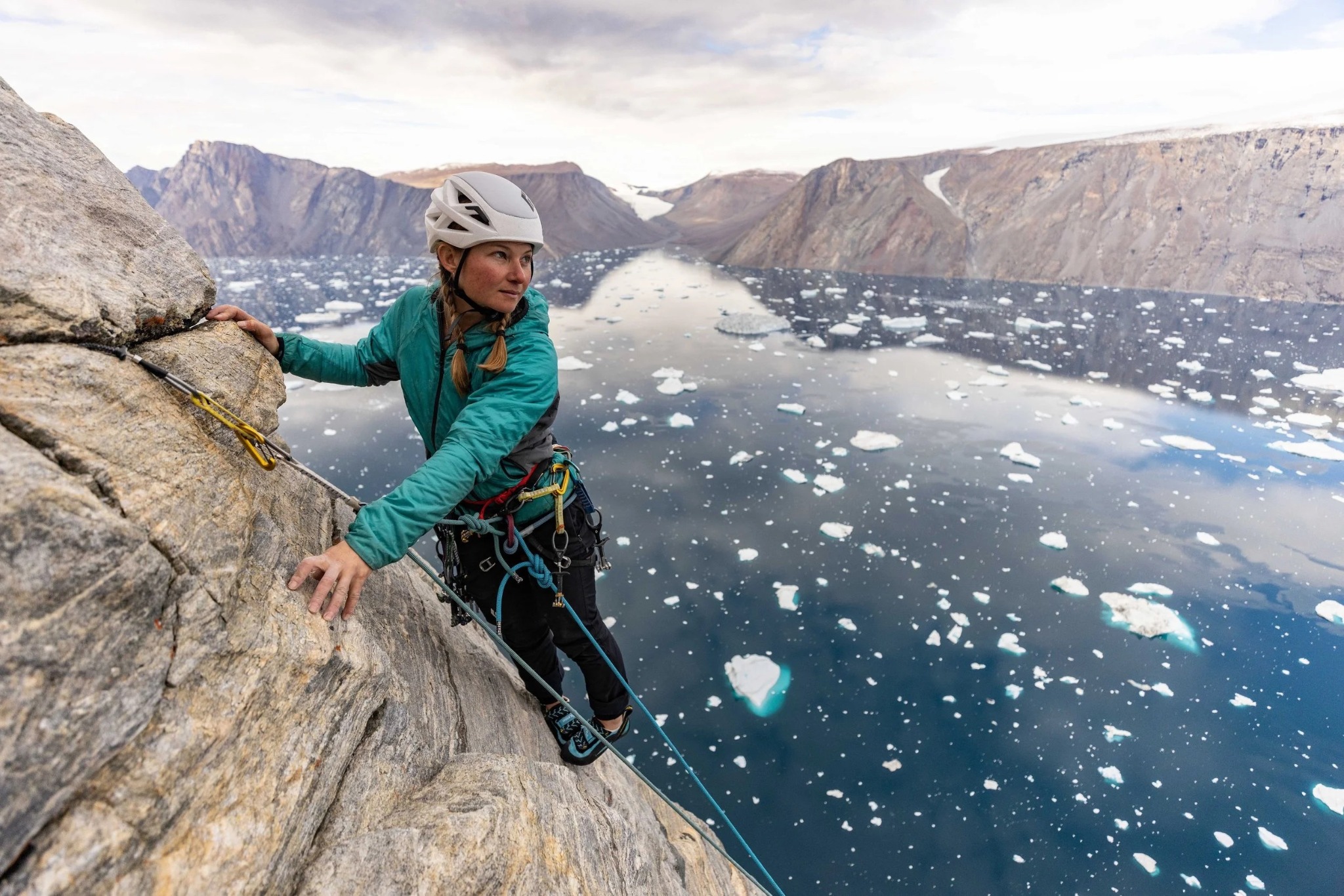 Hazel Findlay climbing above an Arctic fjord