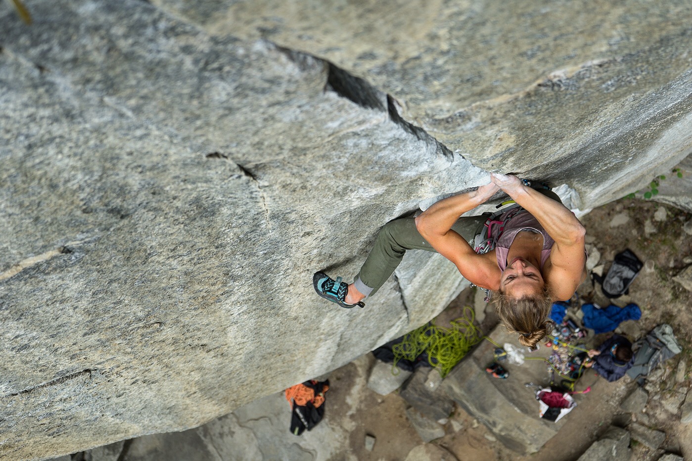 Climber reaching for a hold on an overhanging rock face