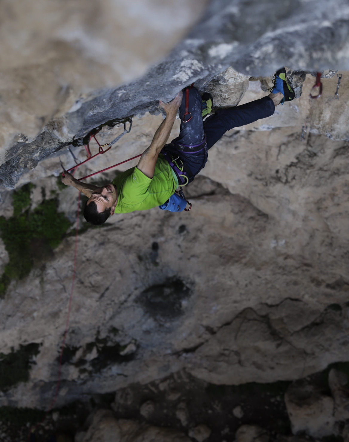 Climber moving through a steep limestone overhang